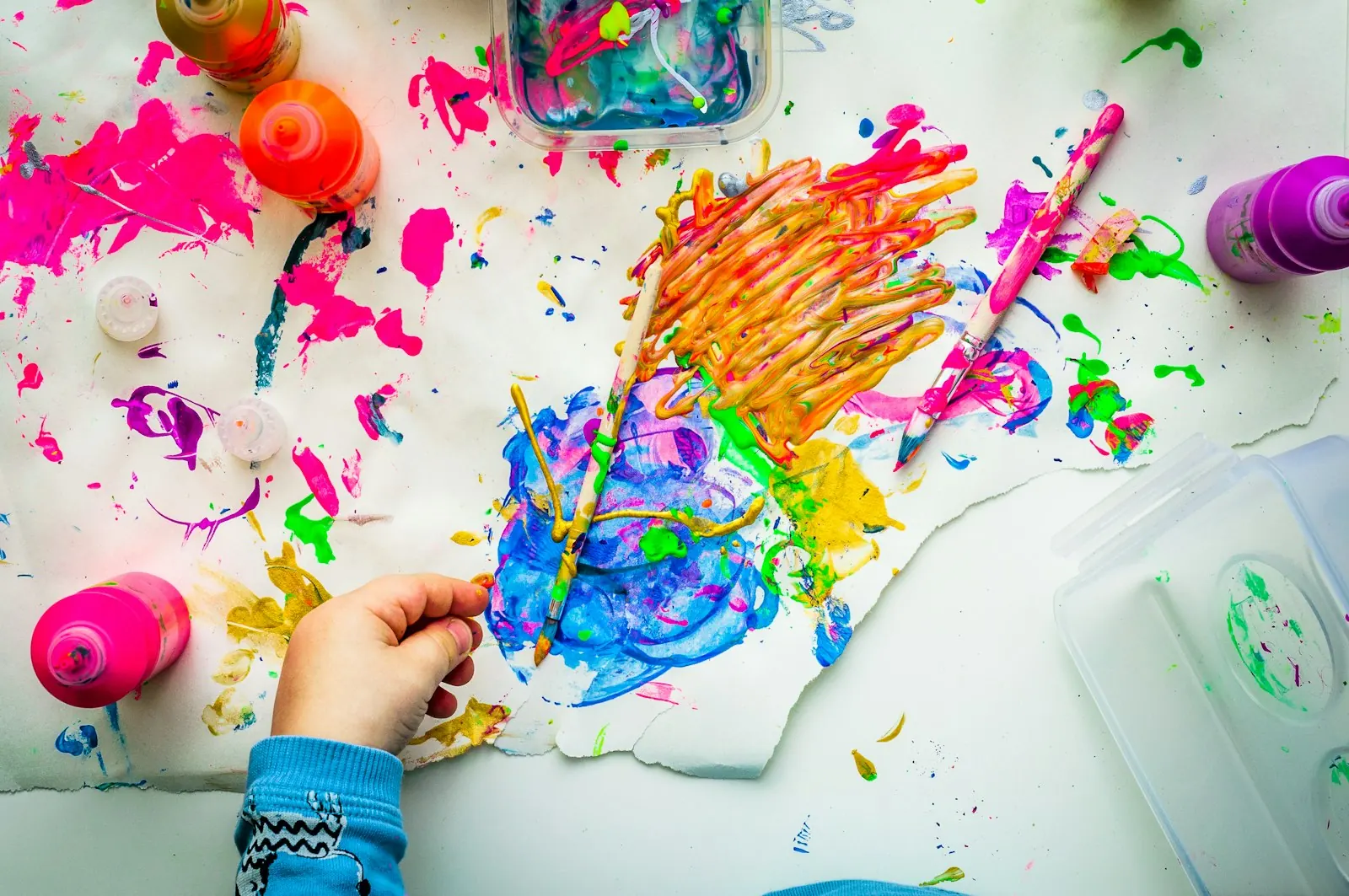 Child painting colourful artwork